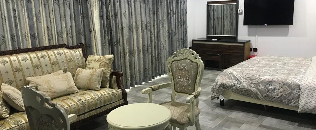 Living room and bedroom interior at Renocks Apartment
