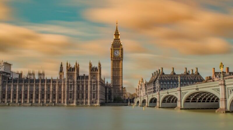brown tower clock under cloudy sy