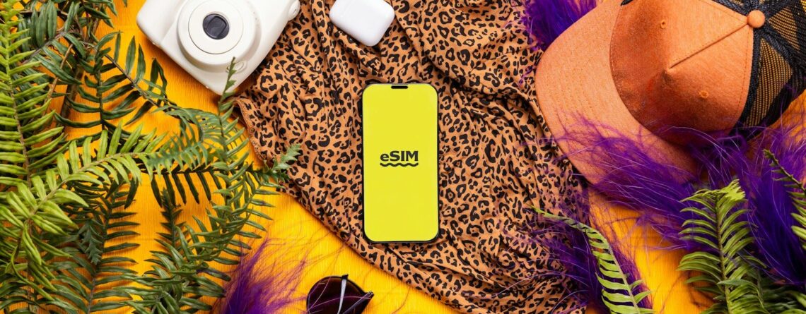 A cell phone laying on top of a lush green plant